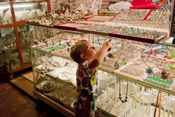 Child browsing through jewelry aisle, Psar Chaa, Siem Reap, Cambodia. Image © Mike Aquino, used with permission.