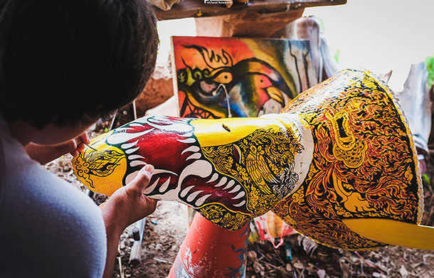 Artisan prepares intricately decorated Phi Ta Kon mask. Image courtesy of the Tourism Authority of Thailand.