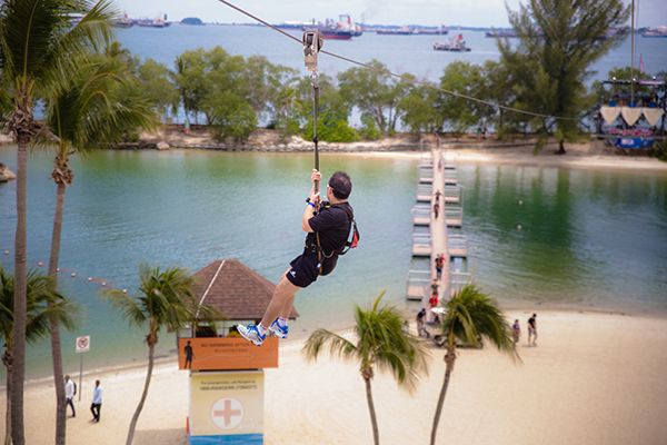 Tourist ziplining down to Siloso Beach, Singapore
